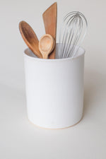 A handthrown ceramic utensil crock in our Kinship Collection off-white glaze.
