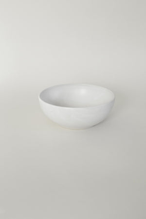 A handthrown ceramic cereal bowl in our Kinship Collection off-white glaze.