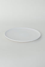 A handthrown ceramic side plate in our Kinship Collection off-white glaze.