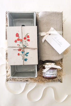 
                
                    Load image into Gallery viewer, A gift box including an herb planter, seed postcards, a lavender honey flower and a linen apron
                
            