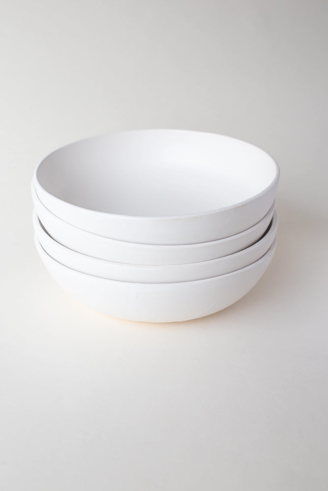 A handthrown ceramic pasta bowl in our Kinship Collection off-white glaze.