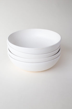 A handthrown ceramic pasta bowl in our Kinship Collection off-white glaze.