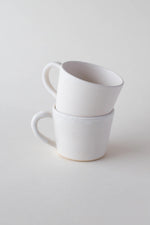 A handthrown ceramic espresso cup and saucer in our Kinship Collection off-white glaze.