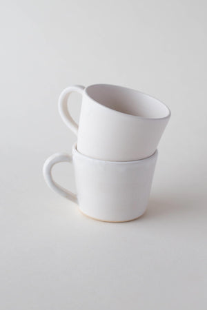 
                
                    Load image into Gallery viewer, A handthrown ceramic espresso cup and saucer in our Kinship Collection off-white glaze.
                
            
