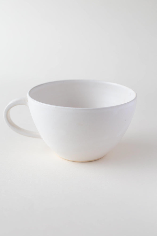 
                
                    Load image into Gallery viewer, A handthrown ceramic tea cup in our Kinship Collection off-white glaze.
                
            