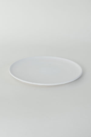 A handthrown ceramic side plate in our Kinship Collection off-white glaze.